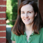 Brenda Edson in front of a brick home