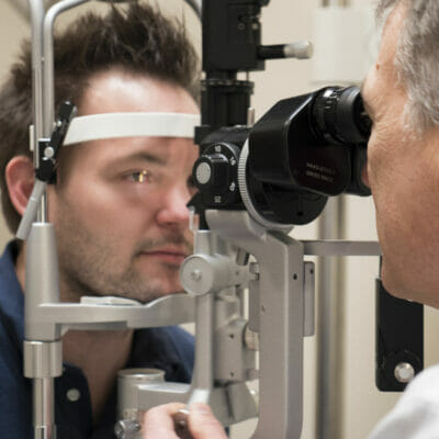 doctor conducting an eye exam on a man